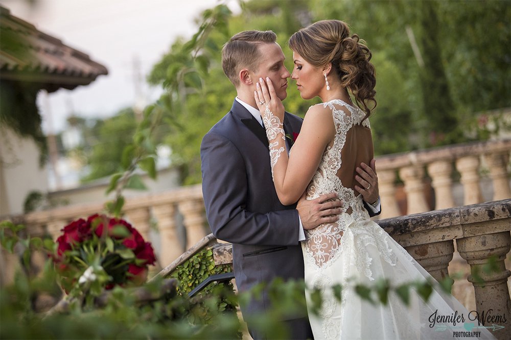 Bride and Groom Embrace on outdoor second floor of Chandelier.jpg