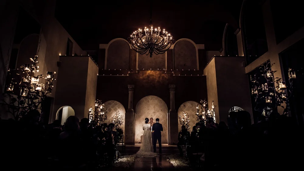 Wedding ceremony at the altar under the grand chandelier at The Bell Tower on 34th, Houston, TX.